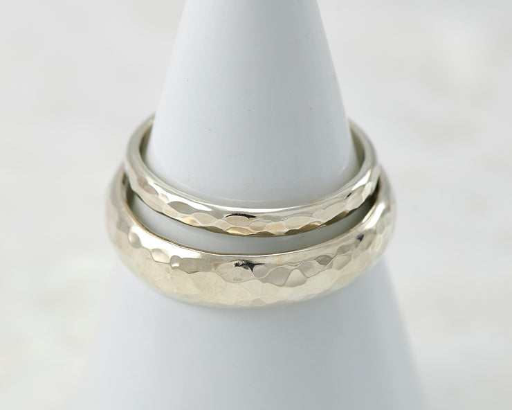 two wedding bands on white ring holder