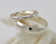 his and hers wedding band set on coral
