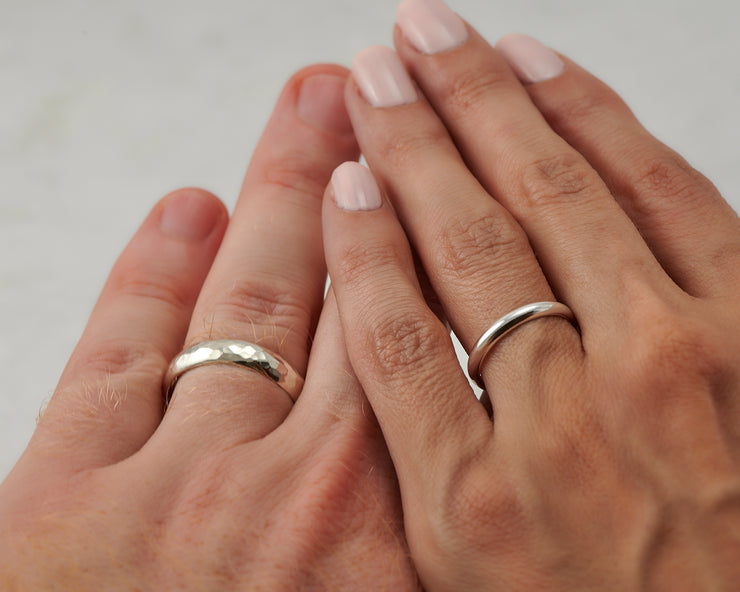 his and hers wedding bands on man and woman's hands