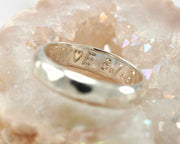 close up of wedding band custom engraving