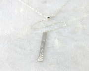 silver bar y-necklace on white marble